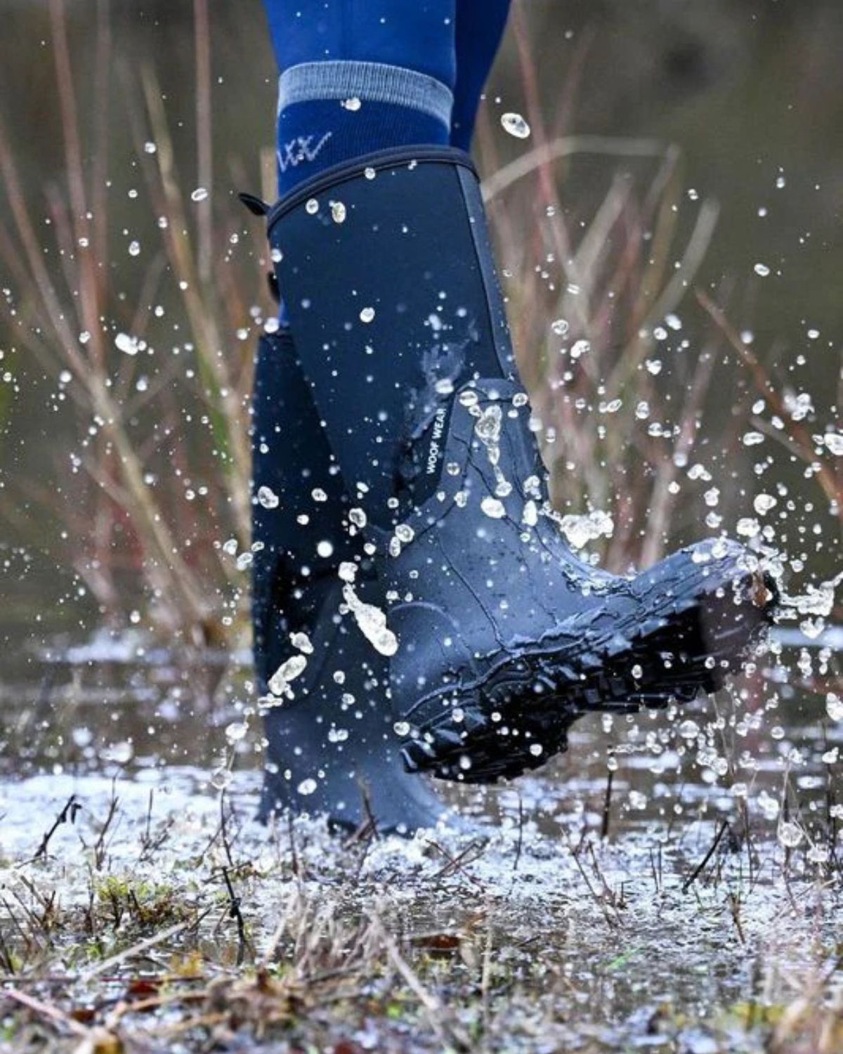 Woof Wear Long Work Boot Black Splashing in Puddle. Waterproof Neoprene Equestrian Boots.