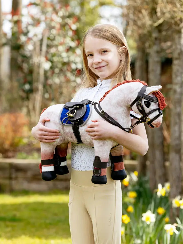 Girl Holding LEMIEUX Toy Pony Capella Boots Brown | Equiflair Equestrian Equipment