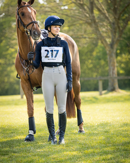 WOOF WEAR EVENT NUMBER BIB BLACK: Equestrian rider and horse at Hickstead event, wearing number 217.