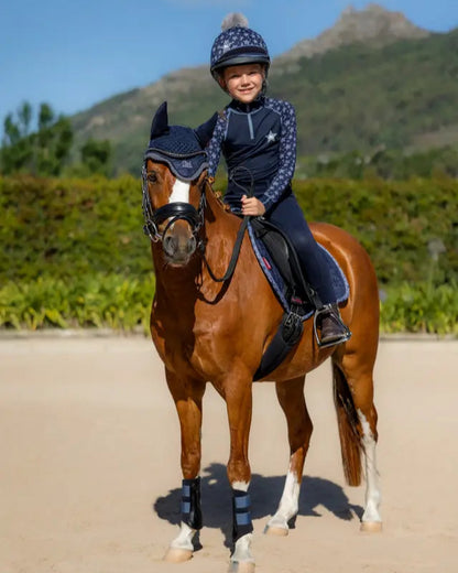 Young rider on horse in LEMIEUX MINI BASE LAYER INDIGO set from Equiflair.