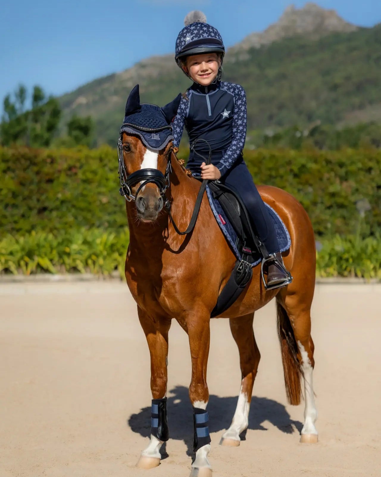 Young rider on pony with LEMIEUX MINI SUEDE JUMP SQUARE INDIGO saddle pad. Perfect for mini riders & ponies. Equiflair