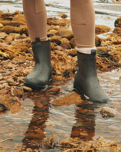 Joules Oakfield Chocolate Brown Short Wellies: Woman in waterproof neoprene boots standing in water.