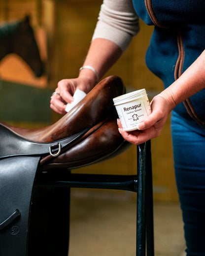 Renapur Leather Balsam applying to clean & condition leather saddle, horse tack care.