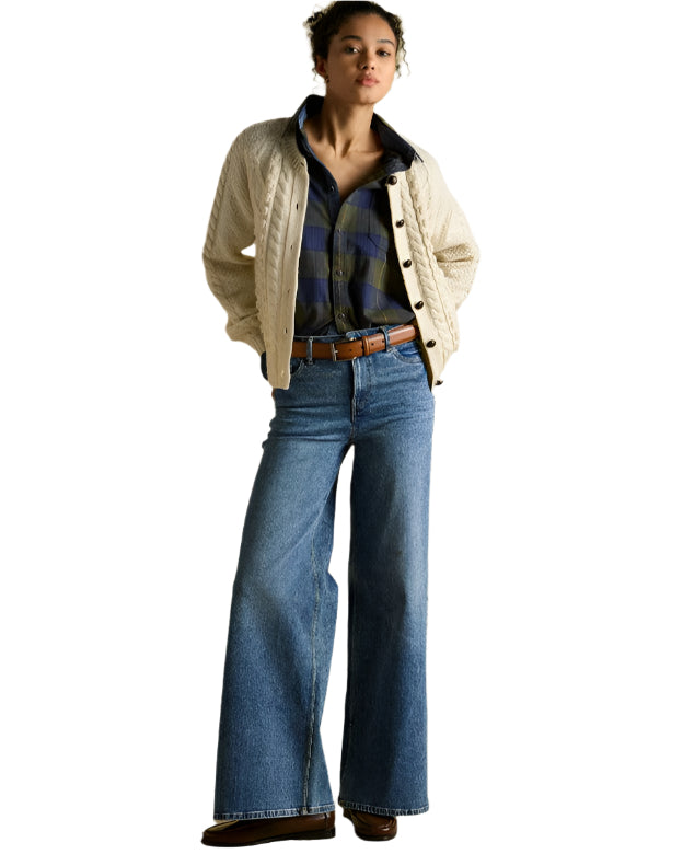 Woman in Cream Cable Knit Cardigan, Plaid Shirt, Wide Leg Jeans, and Brown Belt. Fashion Outfit