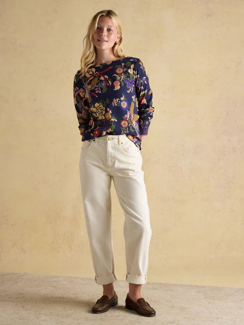 Equiflair: Joules Printed Harbour Navy Bird Top - Woman in floral shirt and white jeans, Joules top