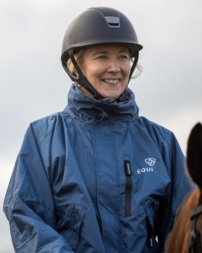 Equestrian Woman in Equidry Steel Blue Riding Coat: Waterproof, Fleece-Lined Jacket by Equiflair