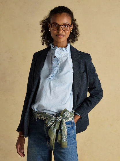Woman wearing Joules Abberton khaki green printed scarf as belt. Lightweight stylish women's fashion accessory.