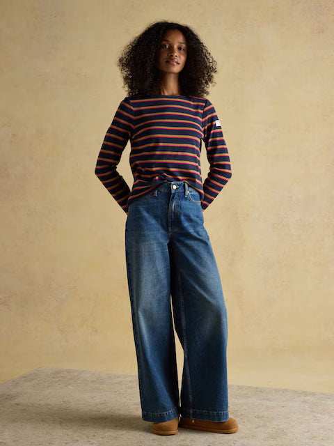 Joules Harbour striped top, wide leg jeans, and brown shoes. Woman wearing stylish casual outfit.