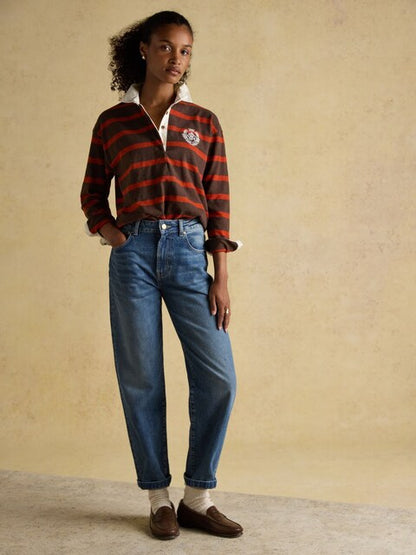 Joules Red & Brown Stripe Boxy Fit Rugby Shirt - Woman Wearing Long Sleeve Striped Shirt, Jeans, Loafers at Equiflair Saddlery