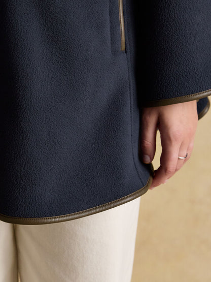 Joules women's navy blue fleece cape with faux leather trim, ideal for warm outdoor wear.