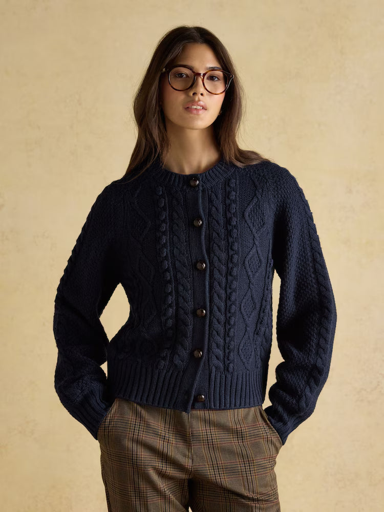 Woman in Navy Cable Knit Cardigan by Equiflair, textured wool sweater, button front, plaid pants