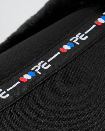 Premier Equine black wool saddle pad: Airtechnology shockproof half pad close up. Equestrian equipment for sensitive horses.