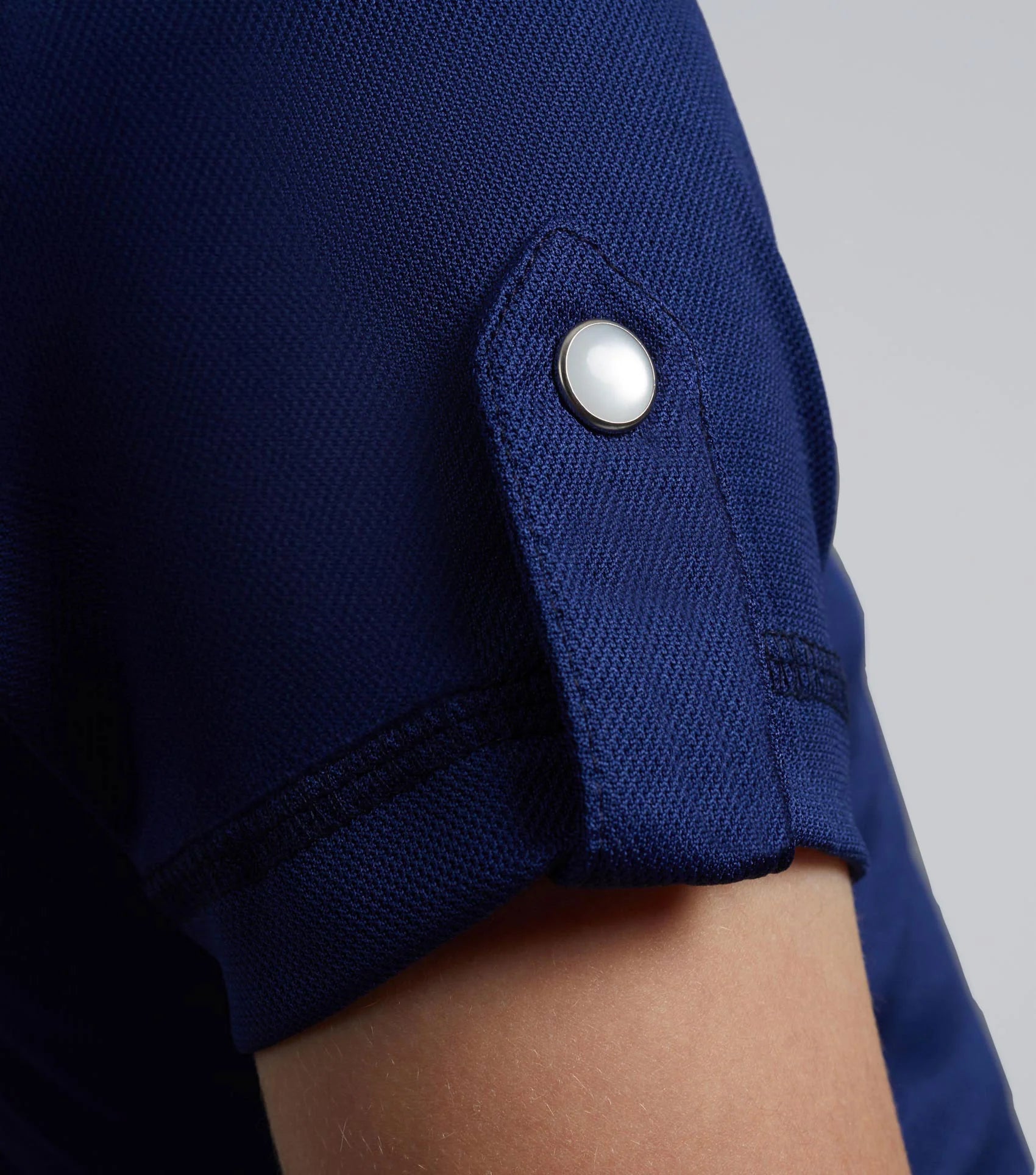 PREMIER EQUINE girl's navy riding top sleeve detail. Technical fabric, popper cuff. Comfortable & breathable equestrian apparel.