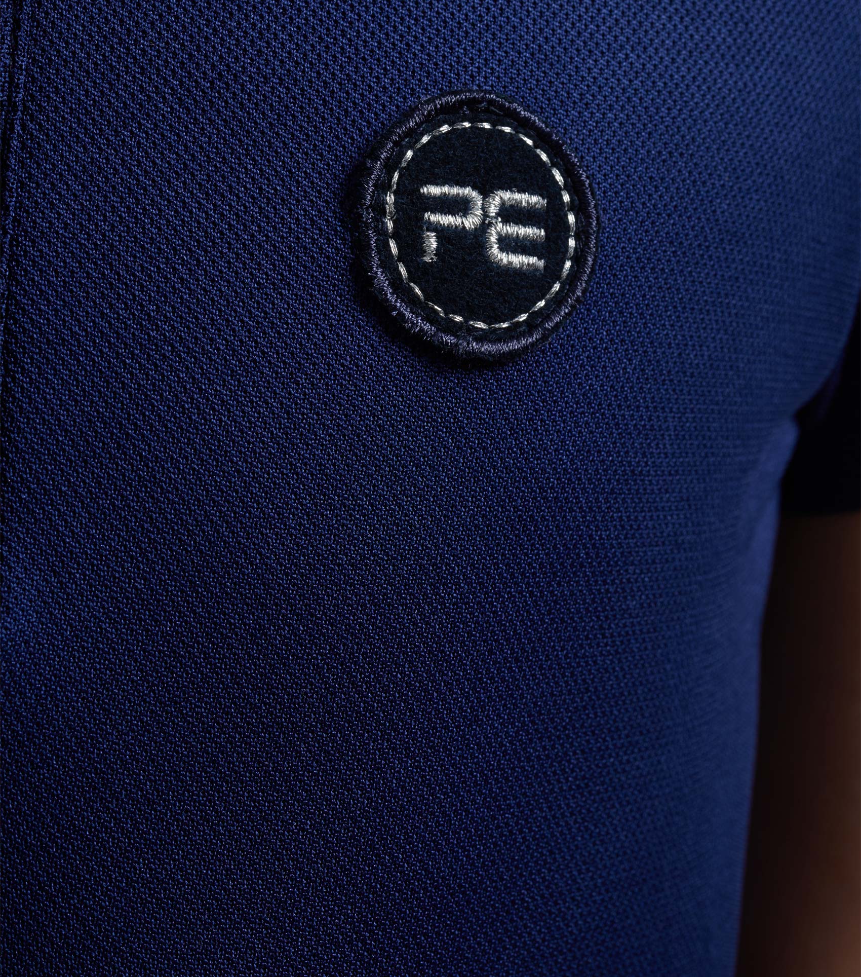 Premier Equine Girl's Navy Riding Top - Technical Short Sleeve Polo Shirt with PE Logo. Comfortable equestrian apparel.