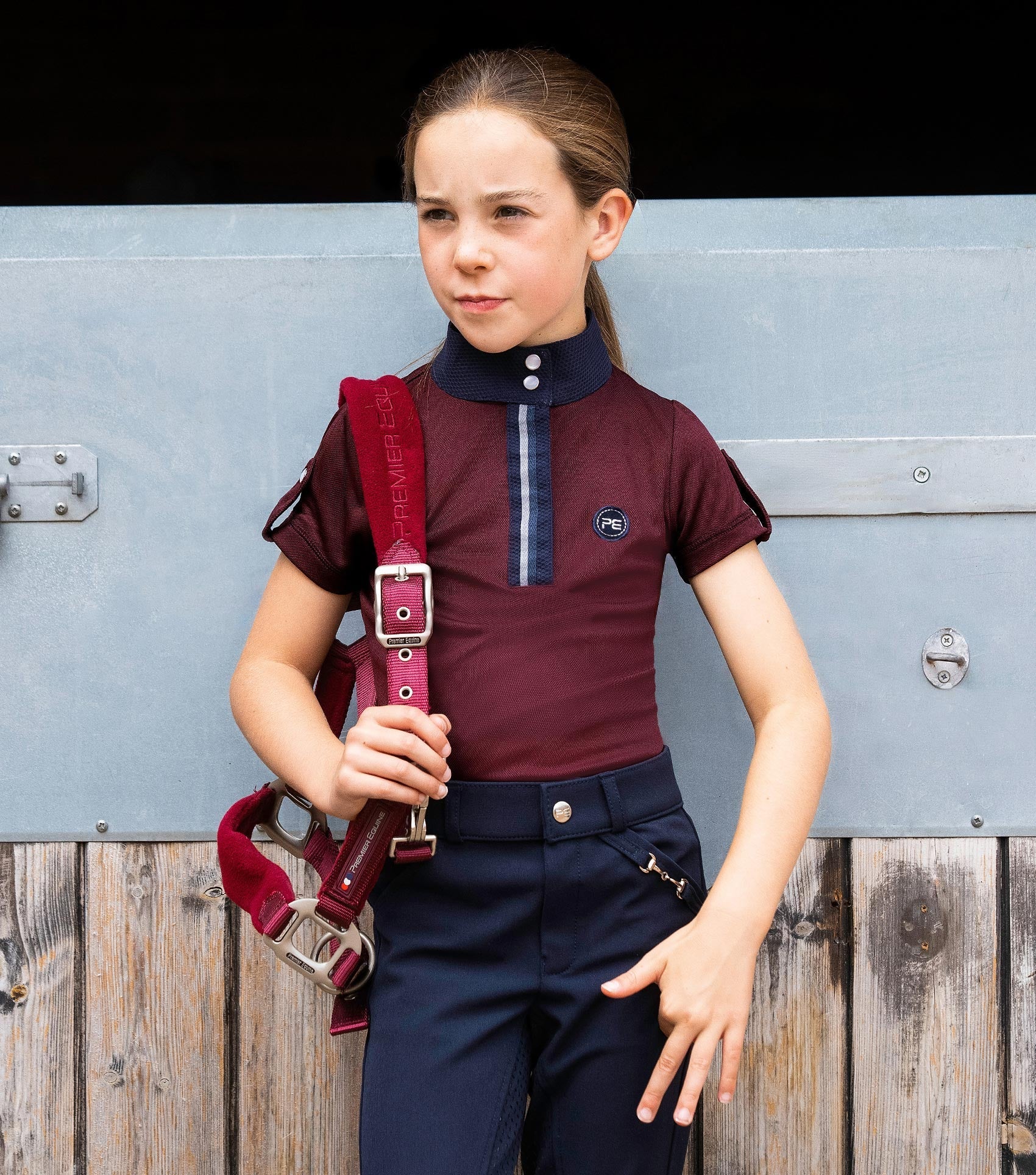 Girl in Premier Equine Wine Riding Top. Short Sleeve Equestrian Shirt for Kids