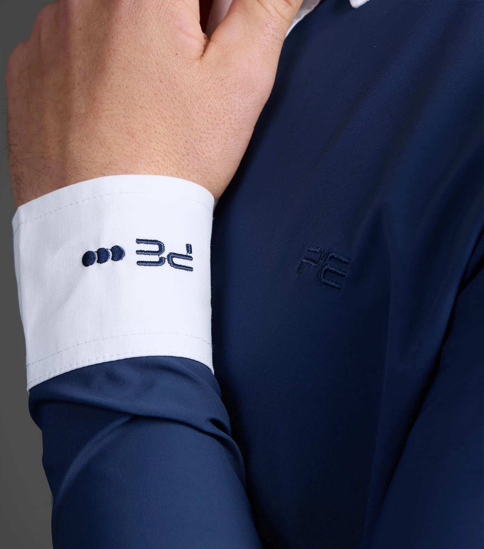 PREMIER EQUINE ANDATE Men's Show Shirt Close-up: White Cuff with Logo. Dressage & Equestrian Competition Apparel
