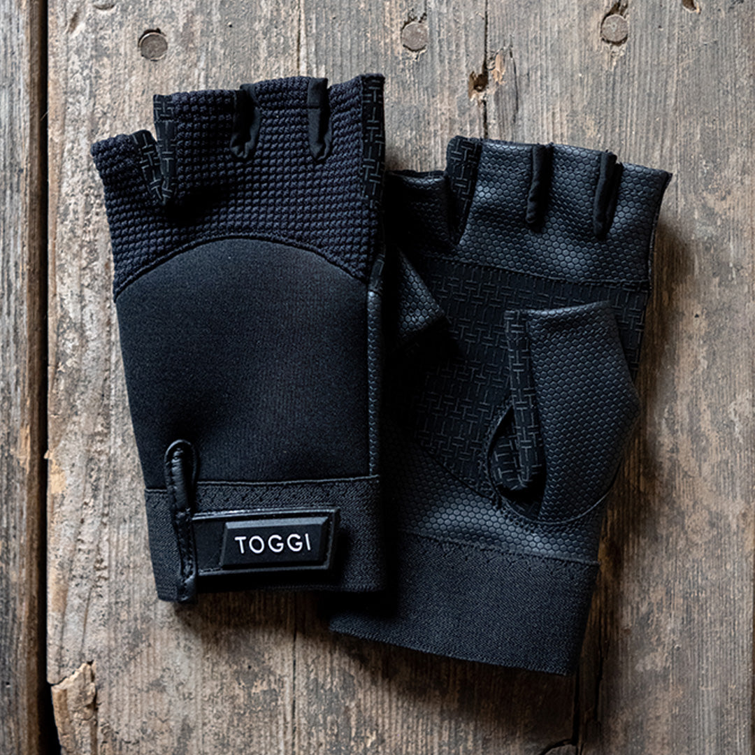 Black TOGGI Ascot fingerless riding gloves with grip panels and adjustable closure for equestrian use.