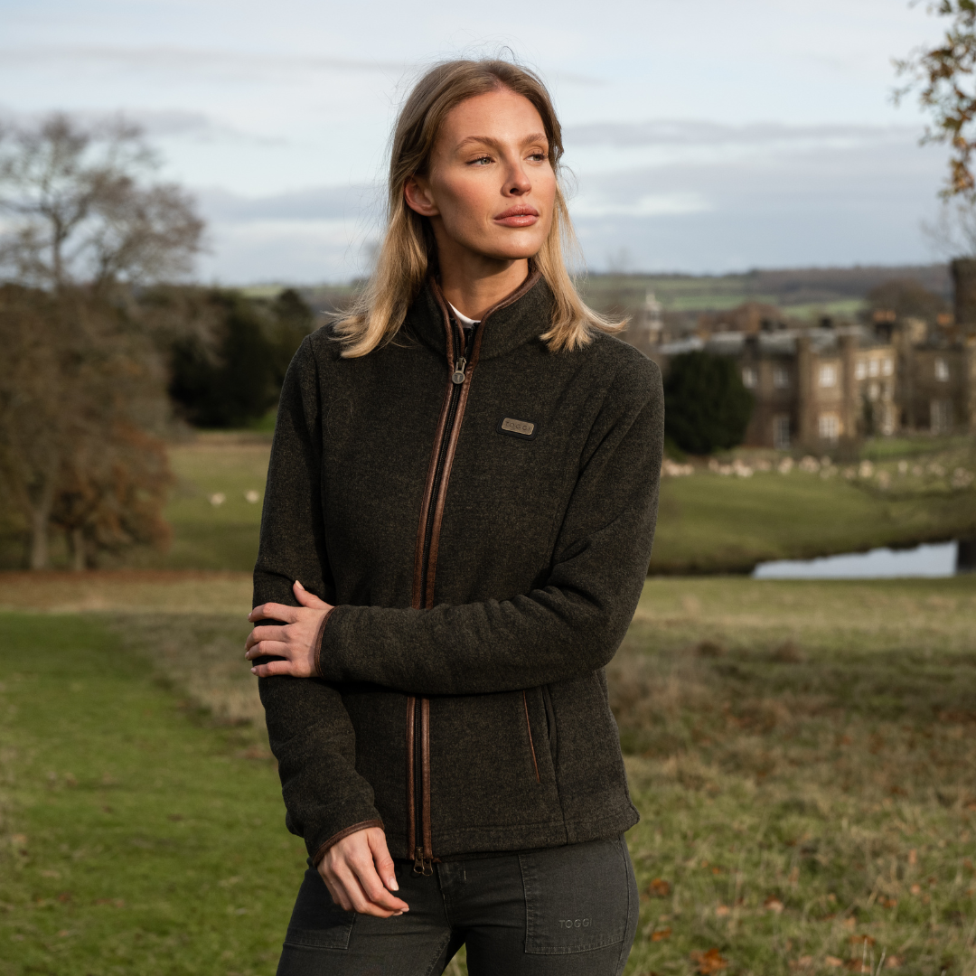 TOGGI Britannia Fleece Jacket: Women's melange fleece with faux leather binding, worn outdoors.