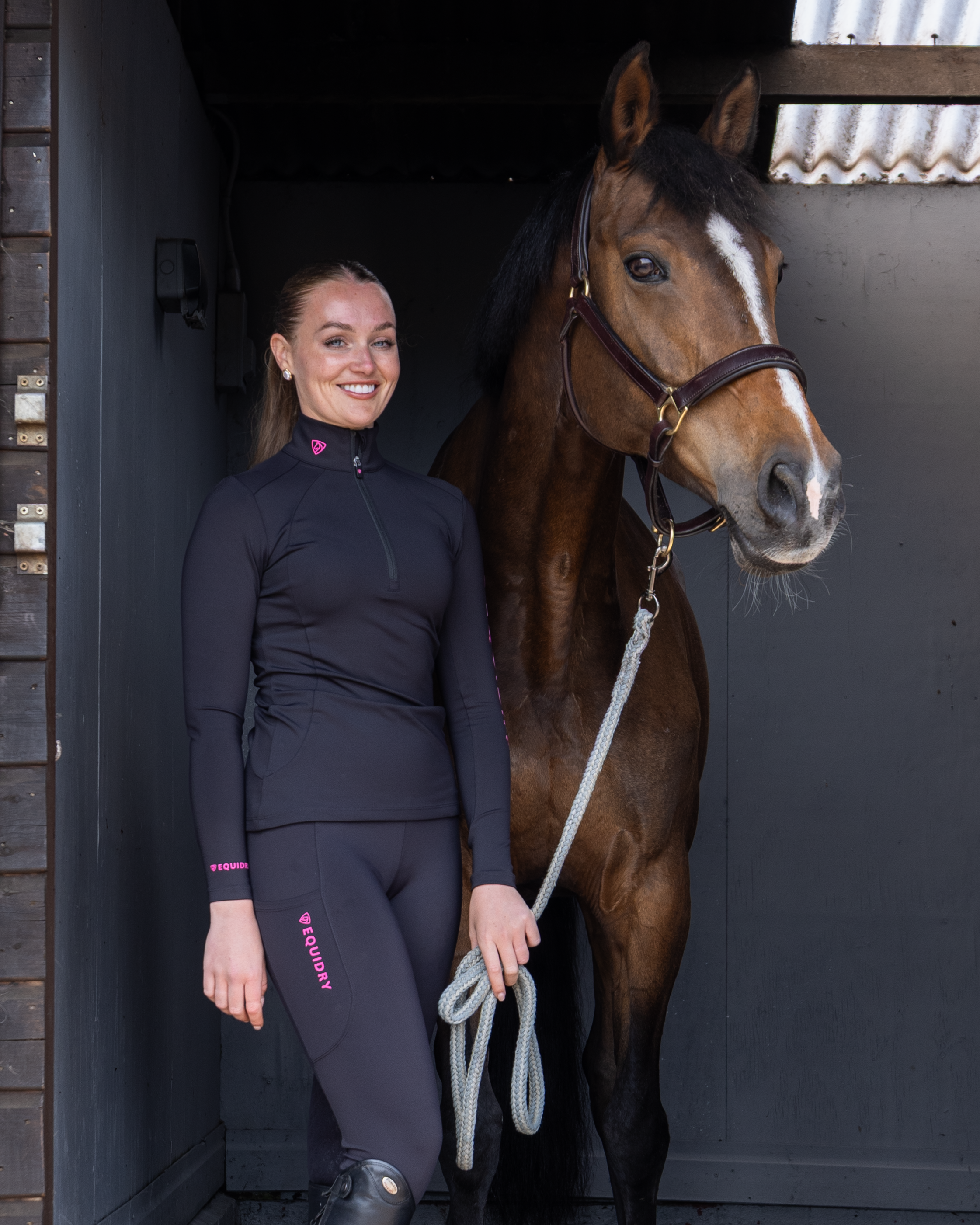 Woman in EQUIDRY Water Repellent Riding Leggings with Horse - Equestrian Apparel
