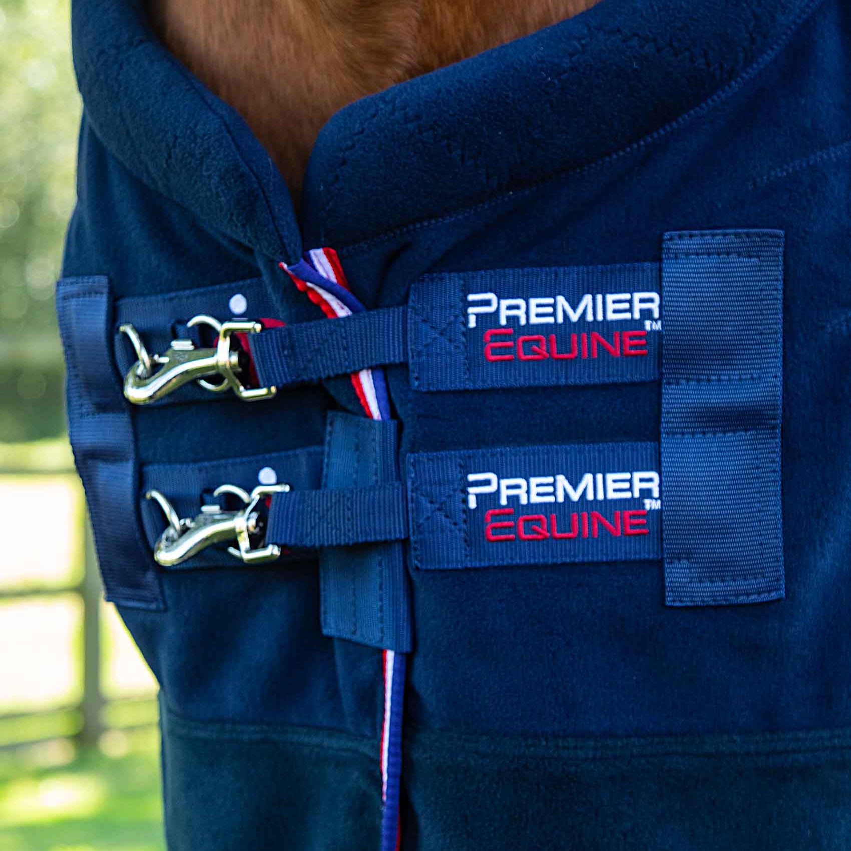 Premier Equine Buster Fleece Cooler Rug - Vecto Edition (Navy). Horse blanket with chest straps and branding detail.