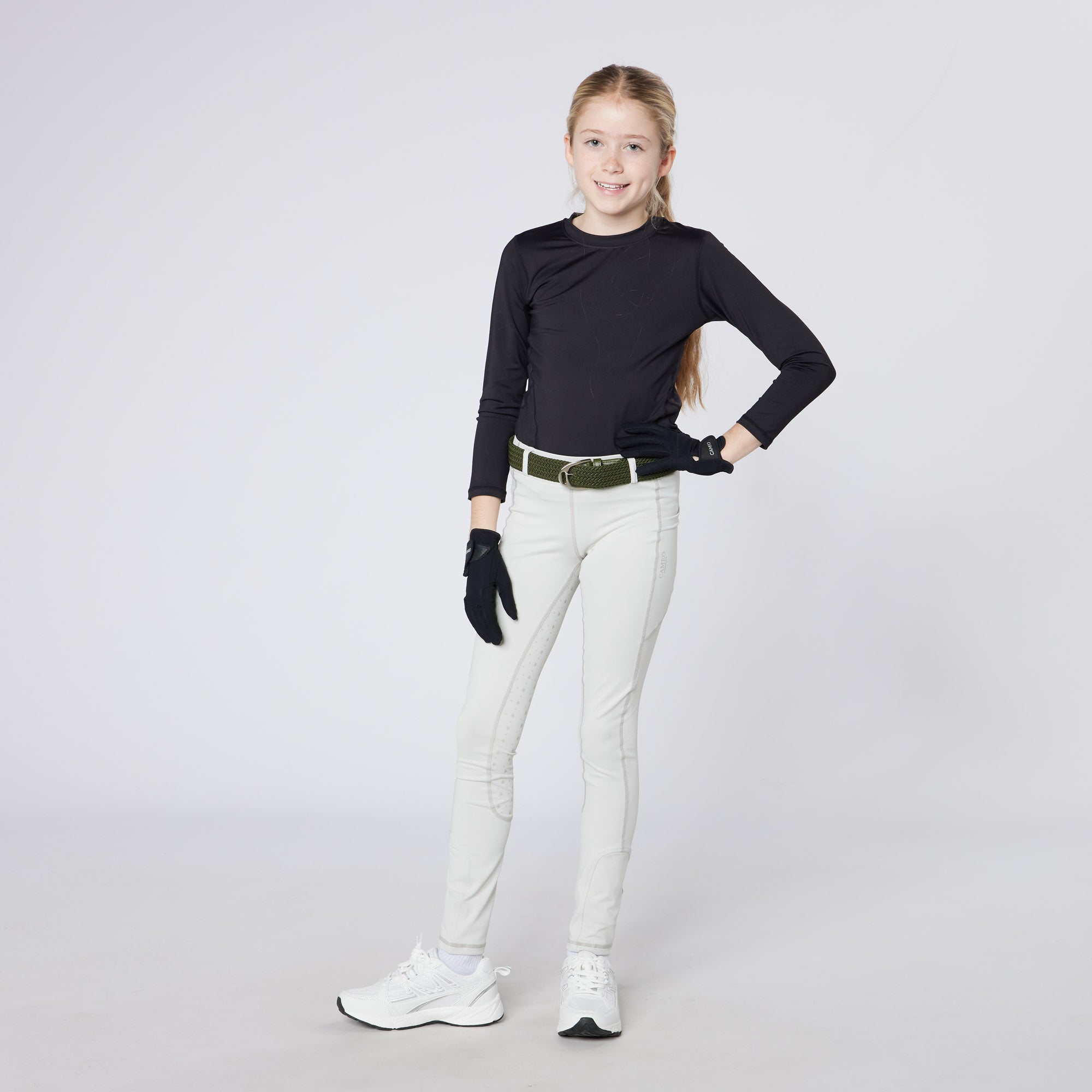 Young girl in CAMEO pale grey riding tights with CameoGrip, black top, & gloves from Equiflair. Junior equestrian apparel.