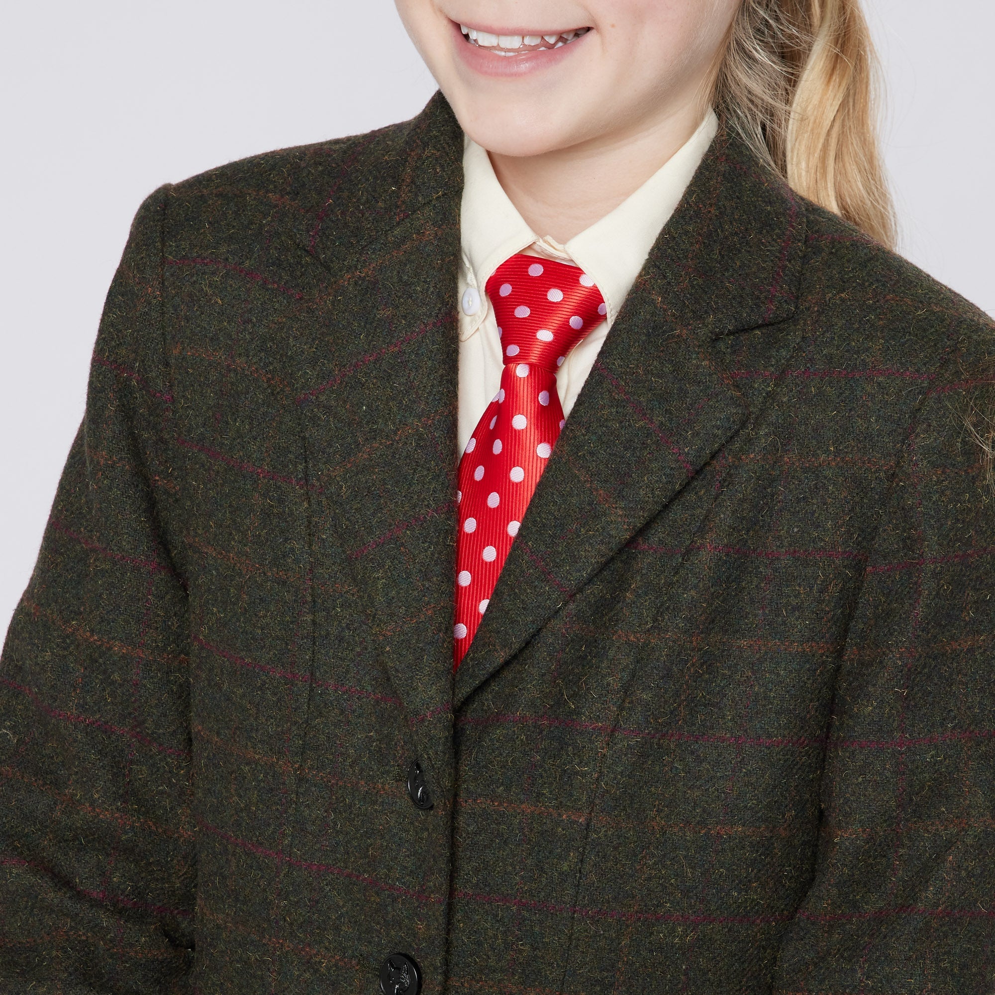 Cameo Junior Tweed Jacket Seaweed Green: Girl in Show Jacket with Foxhead Buttons & Polka Dot Tie. Equestrian Apparel for Young Riders