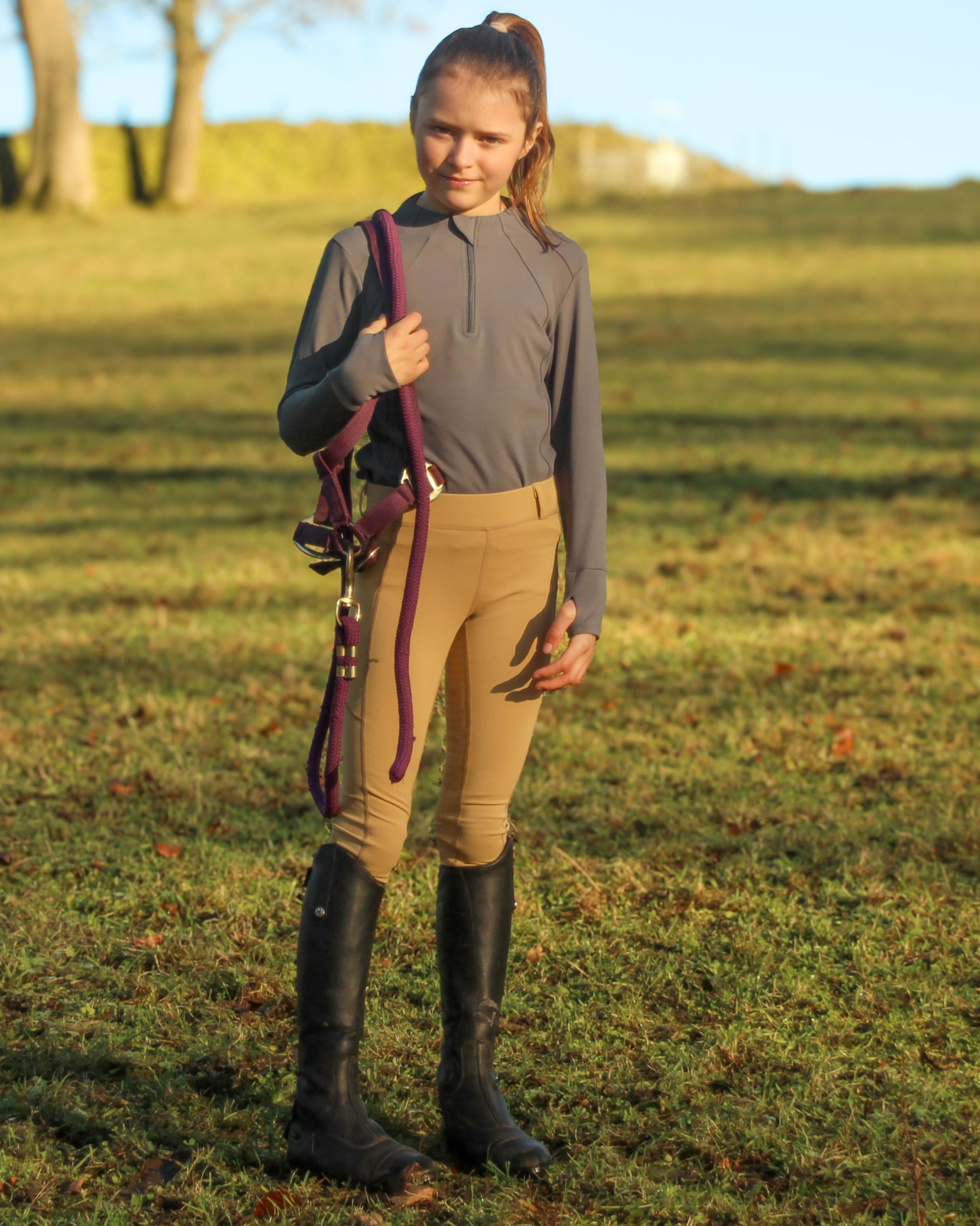 Equiflair: Junior girl in CAMEO BEIGE Thermo Riding Tights. Equestrian apparel for warmth and comfort. #ridingtights #equestrianfashion