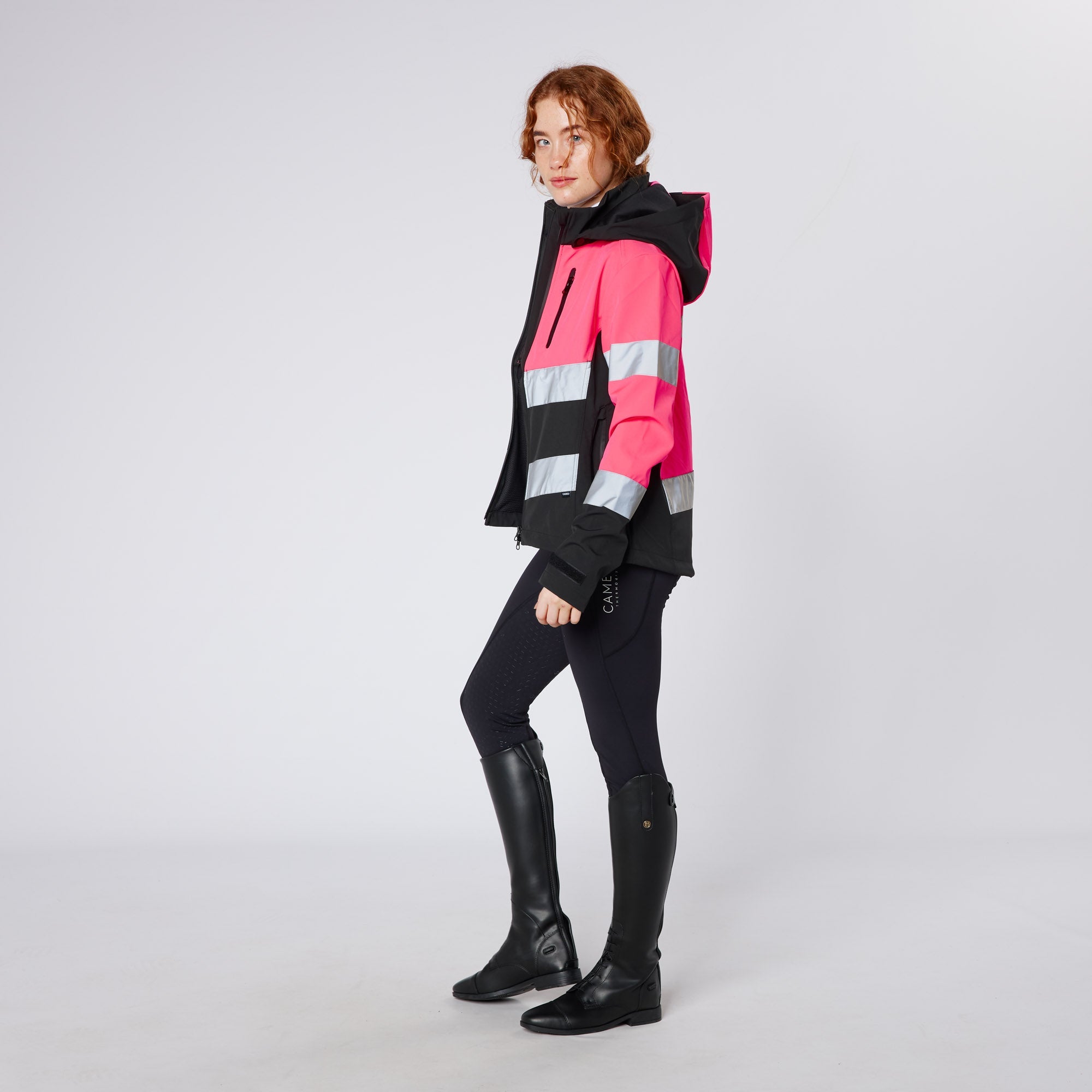 Equiflair CAMEO Pink Hi Viz Riding Jacket: Water Repellent, Reflective. Woman in Equestrian Gear.