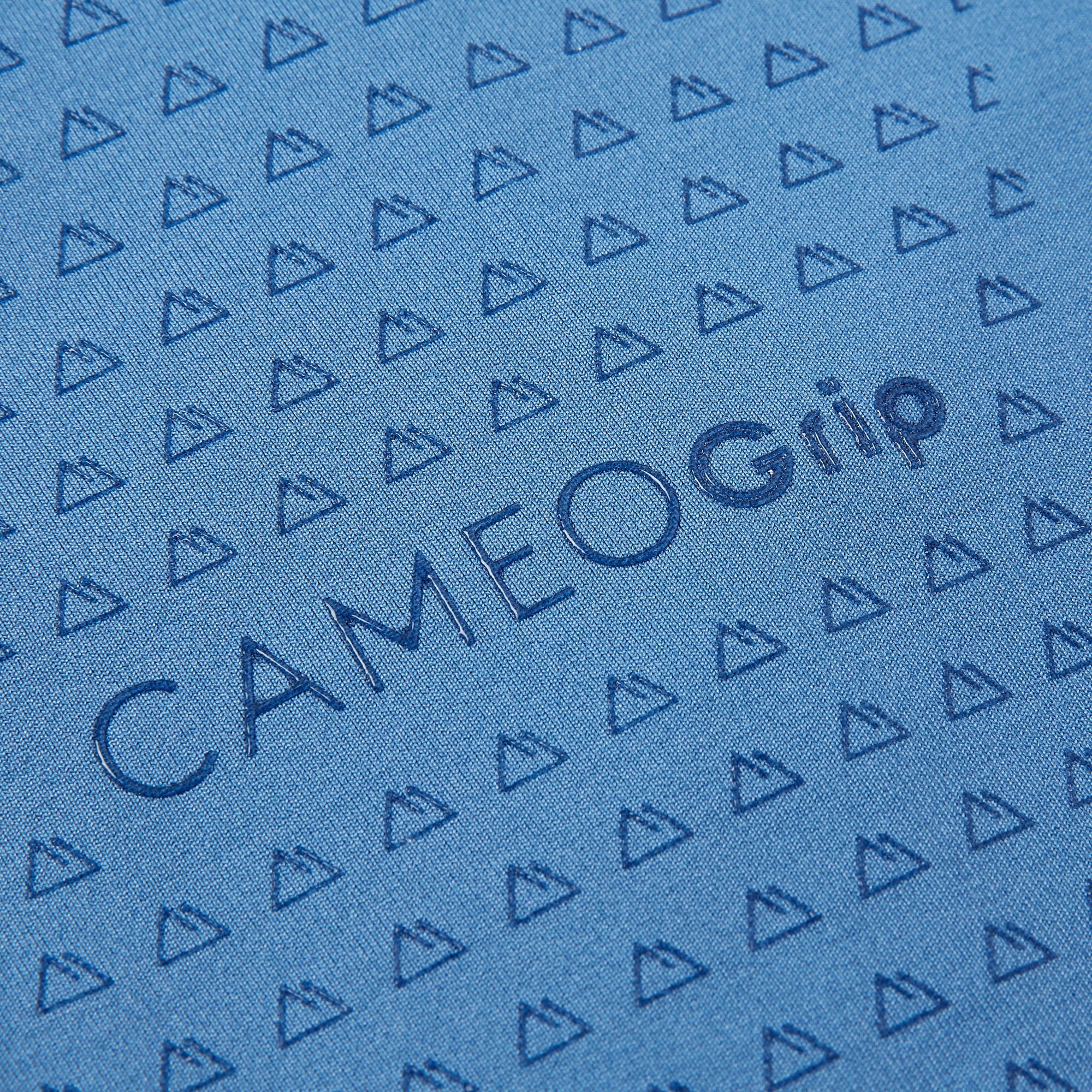 CAMEOgrip Blue Fabric: Close-up of Patterned Material with Mountain Detail and the CAMEOgrip Logo.