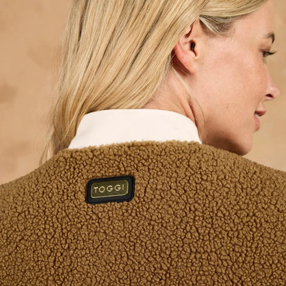 Woman wearing brown TOGGI reversible fleece gilet with quilted detail and metallic TOGGI badge