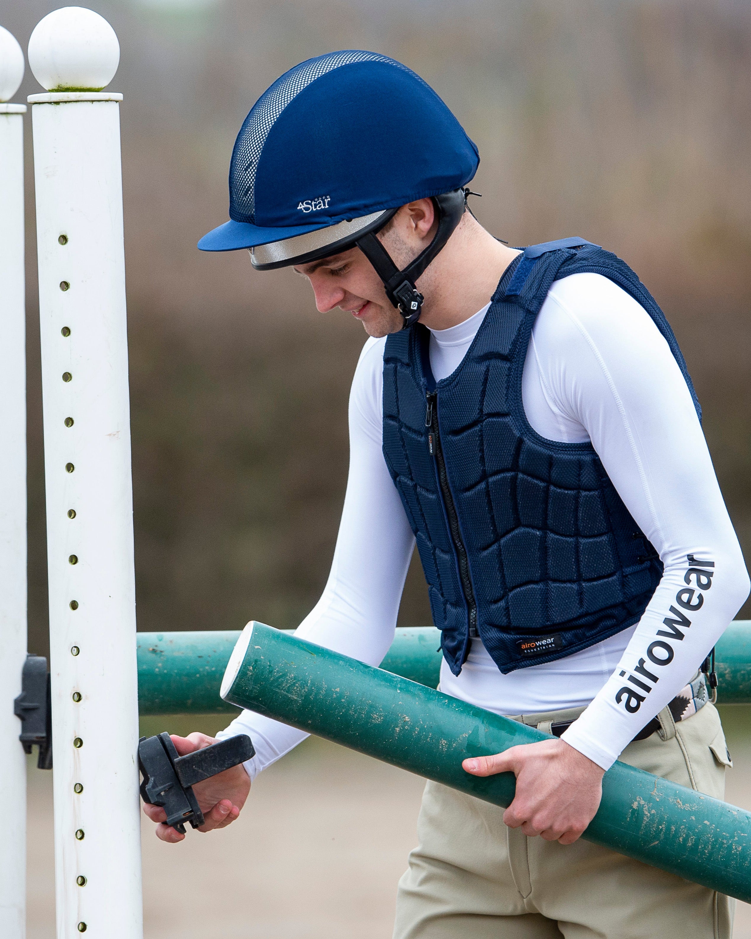 Equestrian with Charles Owen 4Star Helmet Adjusting Jump. Riding Gear: Safety Vest, Long Sleeve.