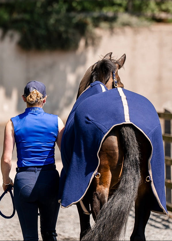 Woman leading horse in Equiflair CAMEO ELEVATE SHOW RUG NAVY. Equestrian apparel, horse blanket. #Equiflair #HorseRug - 6ft