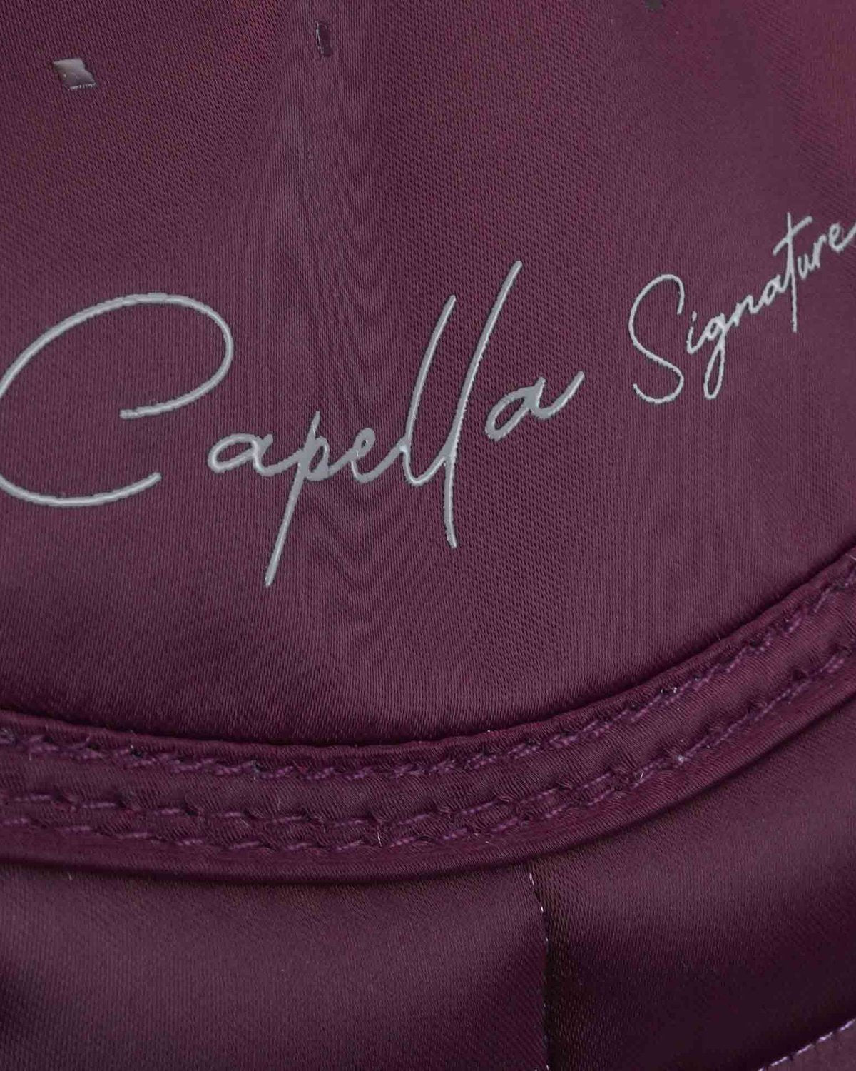 PREMIER EQUINE Capella Dressage Saddle Pad - Wine with Merino Wool. Close up of signature on luxurious quilted design.