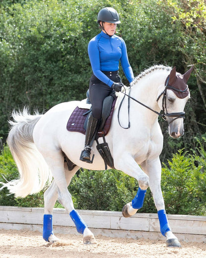 Dressage Horse and Rider with Premier Equine Merino Wool Saddle Pad from Equiflair