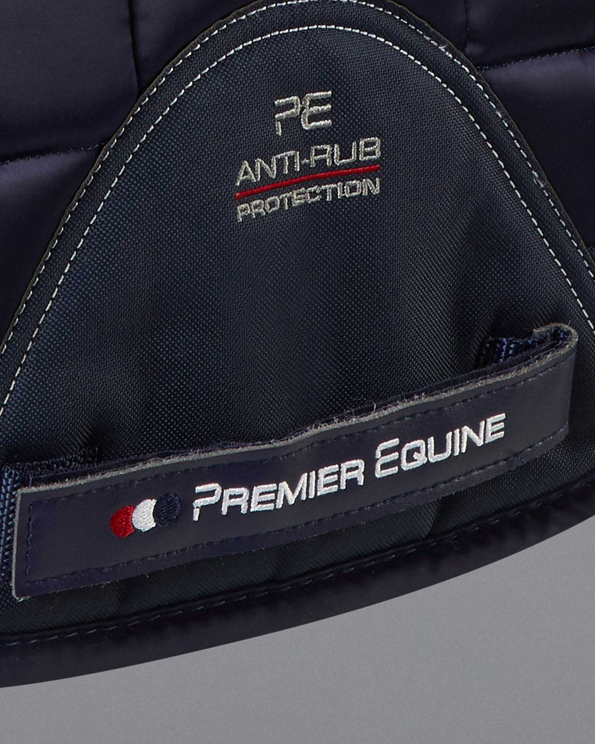 PREMIER EQUINE Capella Merino Wool GP/Jump Saddle Pad - Navy. Close up shot