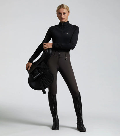 Equestrian Woman in Premier Equine Riding Gear: Carapello Breeches, Riding Top, and Boots. Full Seat Gel Breeches for Women