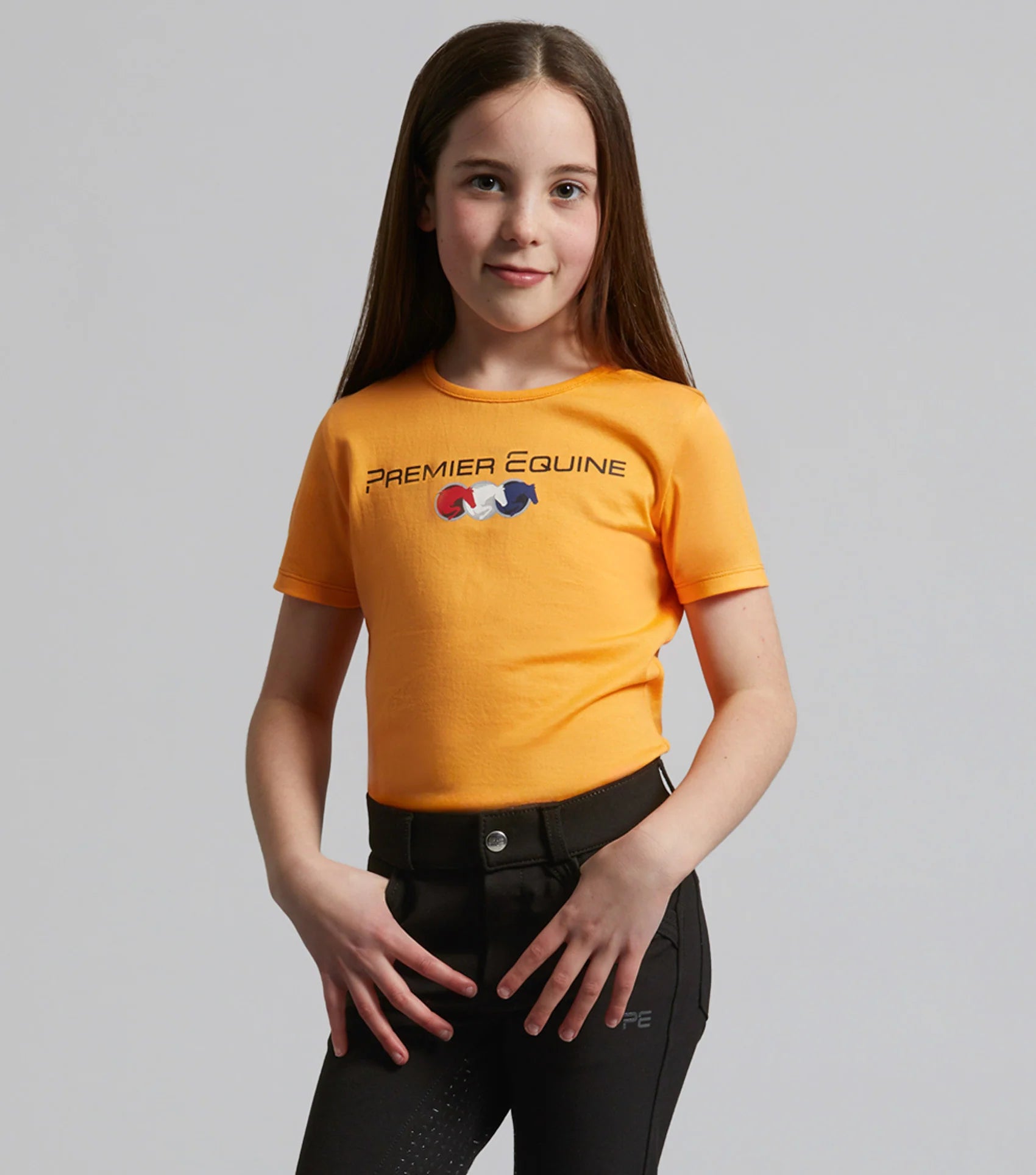 Premier Equine Chiaro Girls Orange Cotton Riding T-Shirt. Equestrian Apparel for young riders.