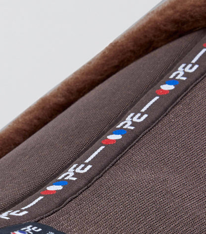 Premier Equine Airtechnology brown GP/Jump wool saddle pad close-up. Superior comfort and performance for your horse.