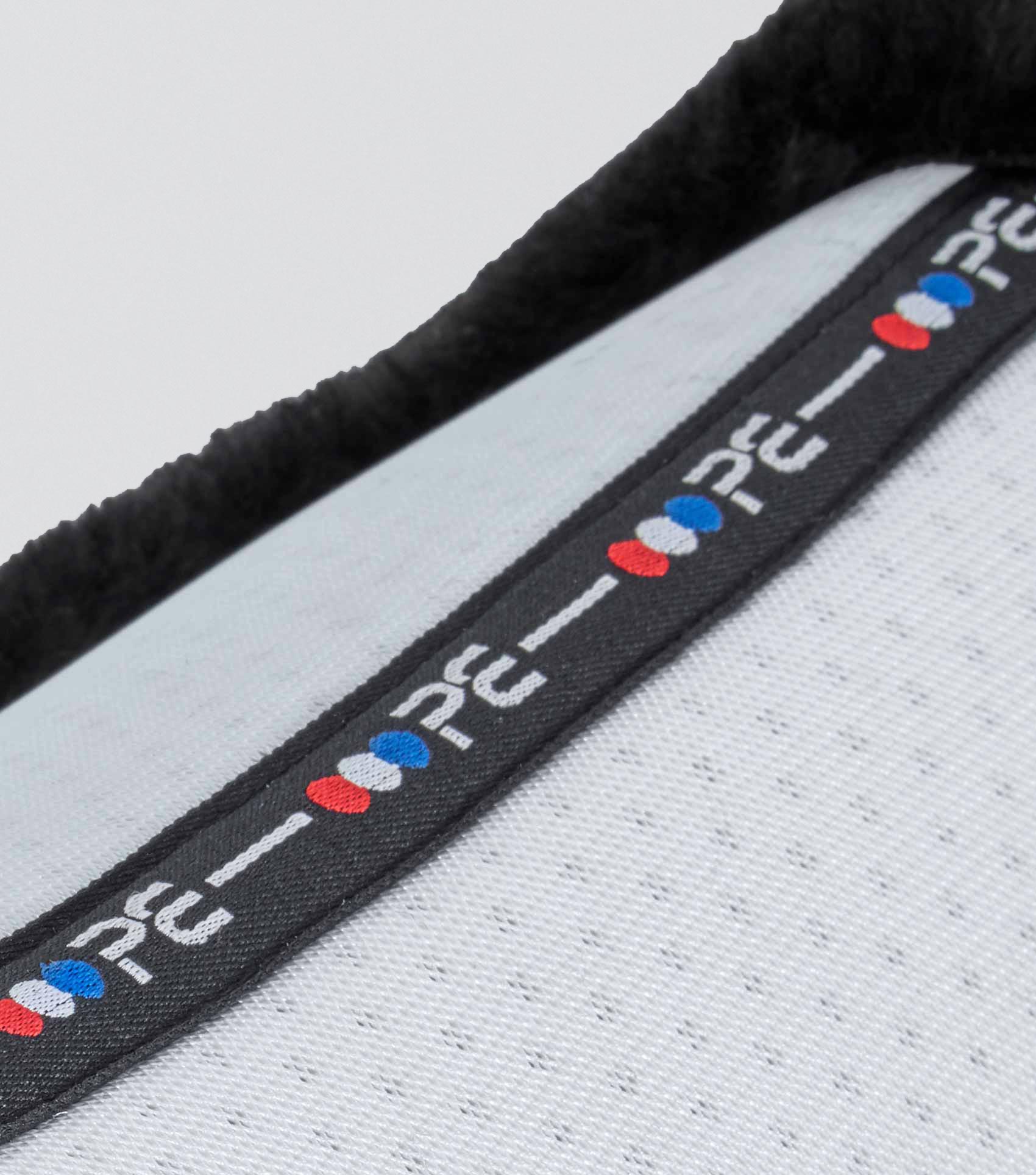 Premier Equine Airtechnology Shockproof Wool GP/Jump Square Saddle Pad - close up on black trim with brand logo