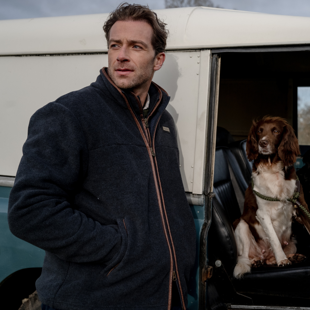 Man with dog next to vehicle wearing TOGGI Downing Fleece Jacket with melange effect