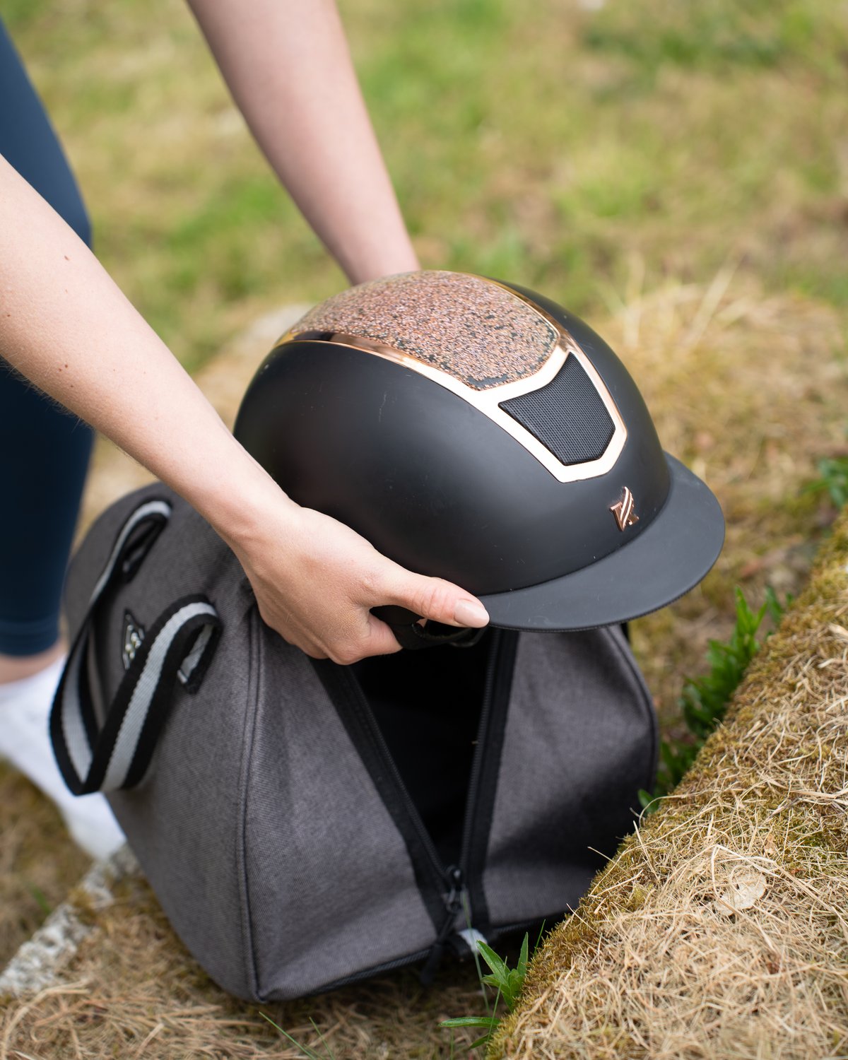 Riding Helmet Being Placed in Woof Wear Grey/Black Hat Bag - Equiflair Equestrian Store