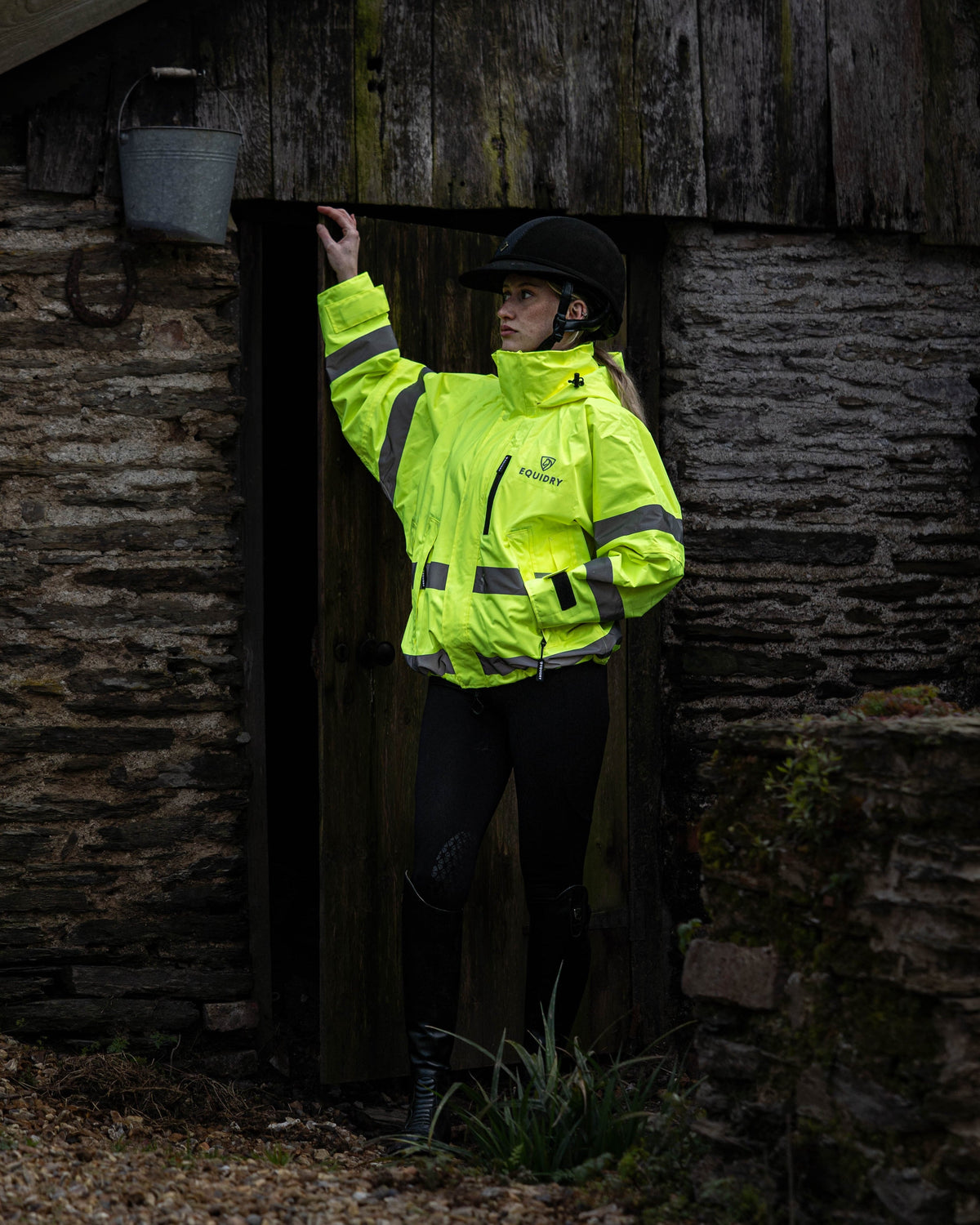 EquiDry hi-vis yellow waterproof riding coat for women, featuring mesh lining and reflective details.