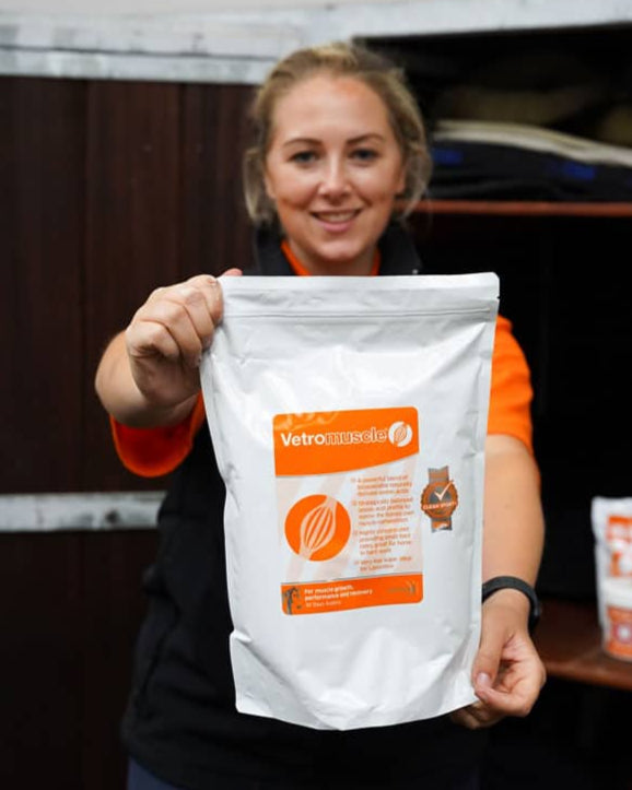 Person holding Vetromuscle equine muscle supplement bag for horses. ANIMALIFE product.