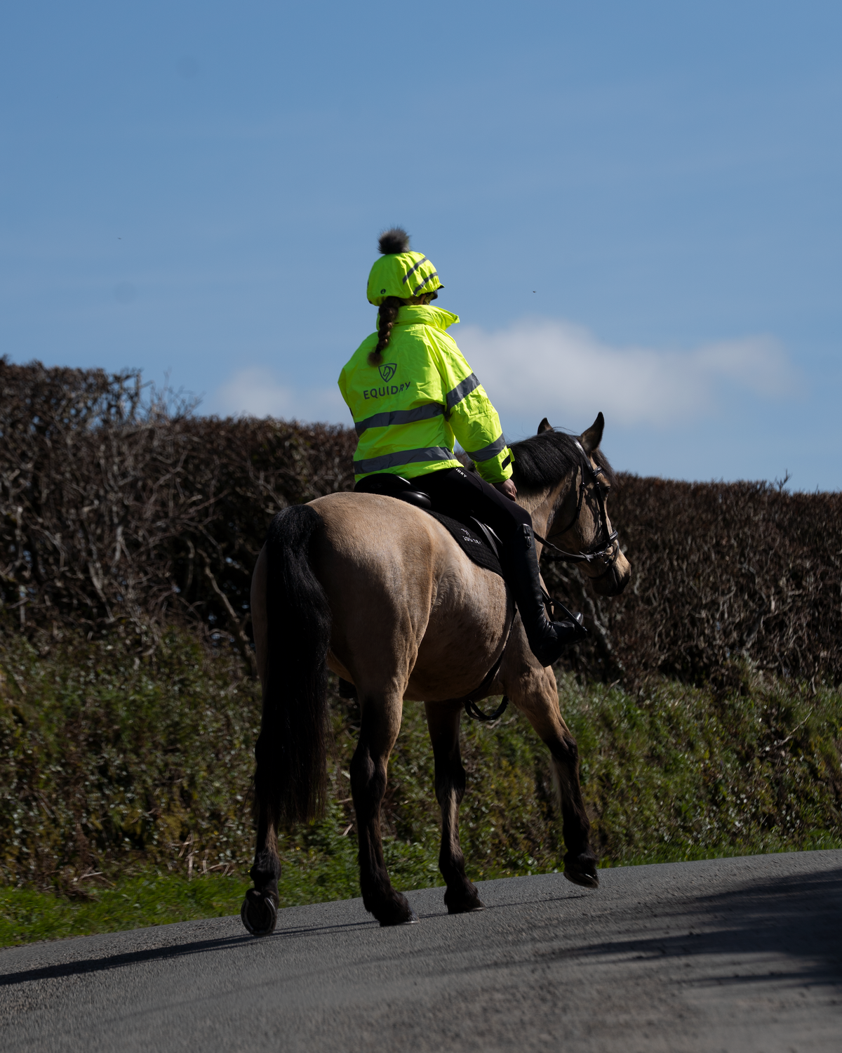 Equidry hi-vis yellow children's riding jacket with reflective details for visibility.