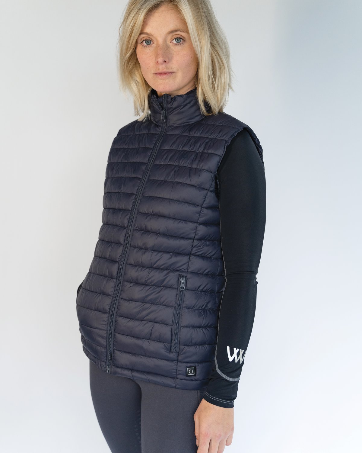 WOOF WEAR Heated Gilet Navy - Woman wearing heated vest. Winter riding apparel from Equiflair.