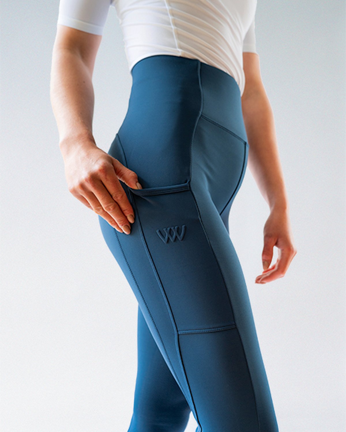 Woof Wear Petrol Blue Riding Tights: High-Waisted, Knee Patch, with Phone Pocket. Comfortable equestrian apparel.