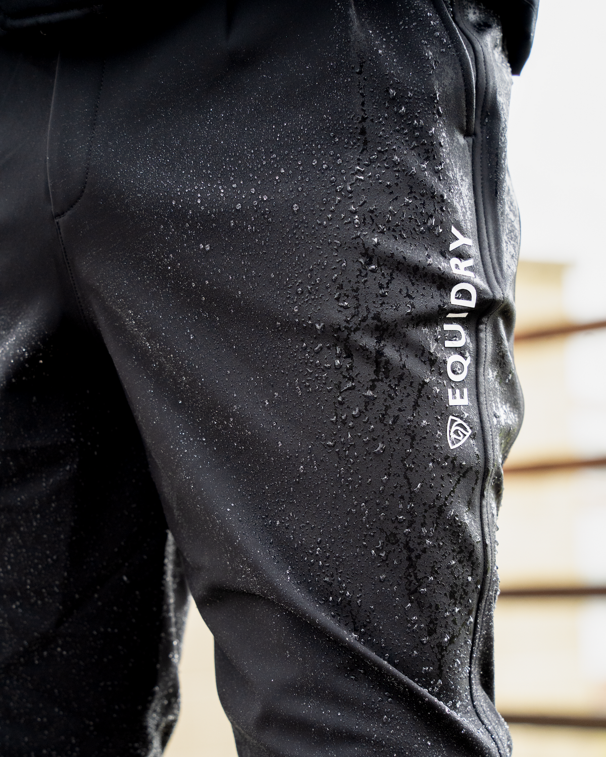 Men's black Equidry waterproof riding breeches with water droplets