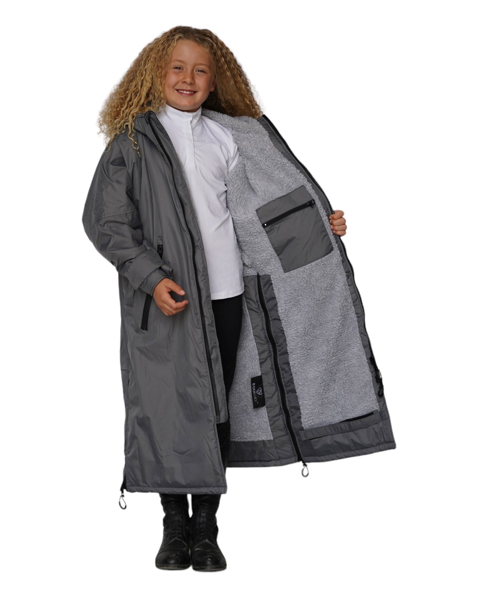 Girl in EQUIDRY Children's Fleece Lined Riding Coat - Grey Waterproof Outerwear for Kids Equestrian Activities.