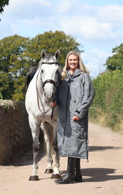 EQUIDRY waterproof horse riding raincoat All Rounder Original thick fleece Women's Charcoal/Grey full view rider stood with horse 