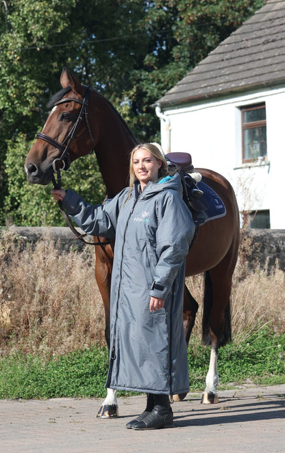 EQUIDRY waterproof horse riding raincoat All Rounder Original thick fleece Women's Charcoal/Turquoise rider stood with horse full view